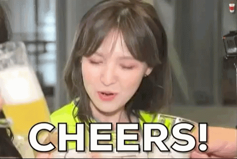 A Woman Is Holding A Glass Of Beer And Making A Cheers Gesture . GIF