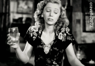 A Woman Is Holding A Glass Of Water In A Black And White Photo .. GIF