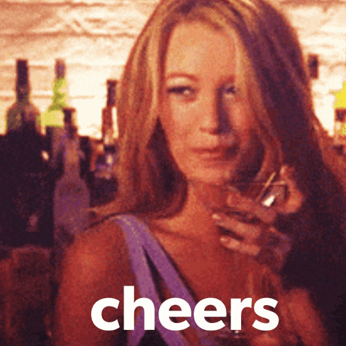 A Woman Is Holding A Glass Of Wine And The Word Cheers Is On The Bottom GIF