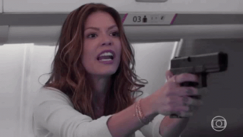 Woman Holding Gun In Front Of Sign 03 GIF