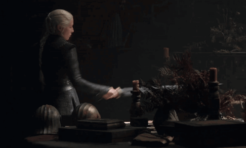 A Woman Is Holding A Large Sword In Her Right Hand GIF