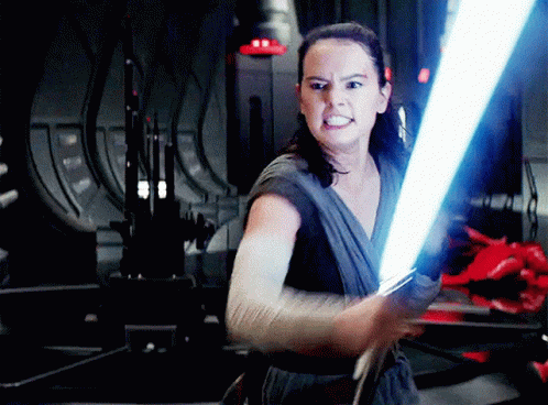 A Woman Is Holding A Light Saber In Her Right Hand GIF