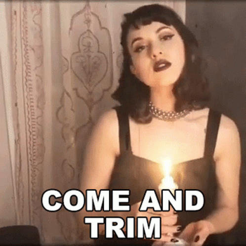 a woman is holding a lit candle with the words come and trim written above her