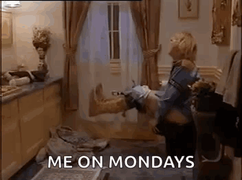 A Woman Is Holding A Man 'S Leg In Her Arms In A Living Room . GIF