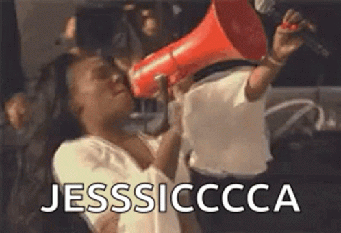 A Woman Is Holding A Megaphone In Her Hand And Shouting . GIF