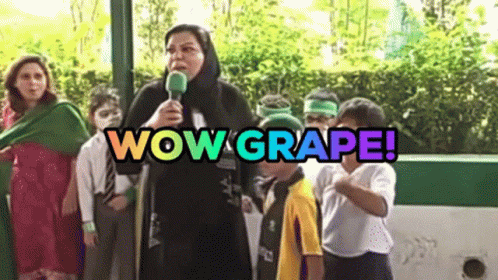 A Woman Is Holding A Microphone In Front Of A Group Of Children And The Words Wow Grape Are Above Her GIF