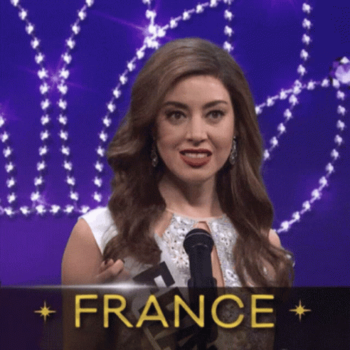 a woman is holding a microphone in front of a sign that says " france "