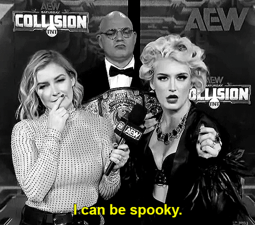 A Woman Is Holding A Microphone In Front Of A Sign That Says I Can Be Spooky GIF
