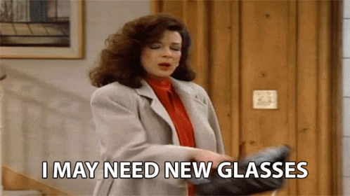 A Woman Is Holding A Pair Of Glasses And Says I May Need New Glasses GIF