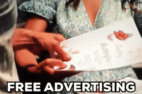 A Woman Is Holding A Pamphlet That Says " Free Advertising " On It GIF