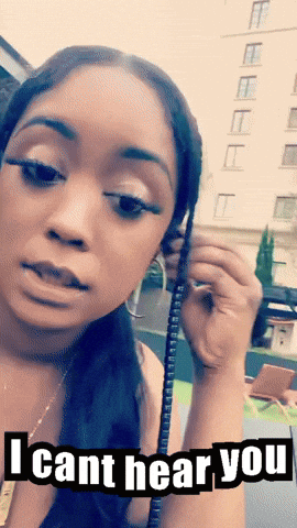 A Woman Is Holding A Phone With The Words I Cant Hear You On The Bottom GIF