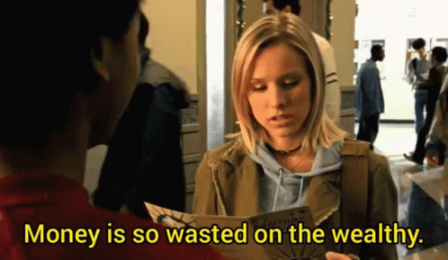 A Woman Is Holding A Piece Of Paper With The Words Money Is So Wasted On The Wealthy GIF
