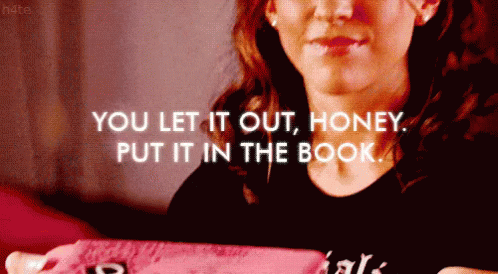 A Woman Is Holding A Pink Book With The Words " You Let It Out Honey Put It In The Book " GIF