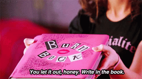 A Woman Is Holding A Pink Burn Book In Her Hands And Saying `` You Let It Out , Honey . Write In The Book . '' GIF