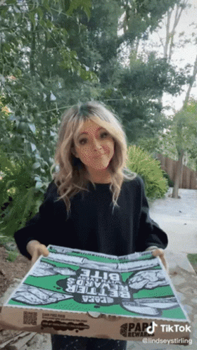 A Woman Is Holding A Pizza Box That Says Papa John 'S On It GIF