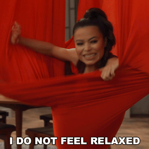 A Woman Is Holding A Red Cloth With The Words " I Do Not Feel Relaxed " Next To Her GIF