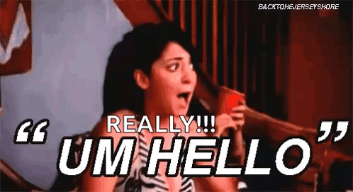 A Woman Is Holding A Red Cup And Saying `` Um Hello '' While Sitting On A Bed . GIF