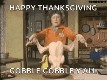 A Woman Is Holding A Roasted Turkey In Her Hands . GIF