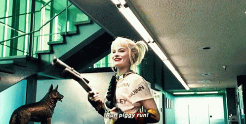 A Woman Is Holding A Shotgun In A Room With Stairs And A Dog In The Background . GIF