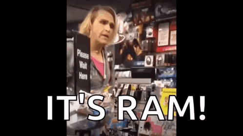 A Woman Is Holding A Sign That Says It 'S Ram . GIF