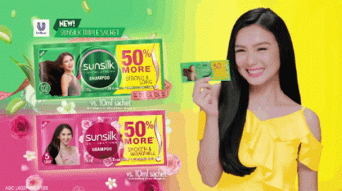 A Woman Is Holding A Sunsilk Sachet In Her Hand GIF