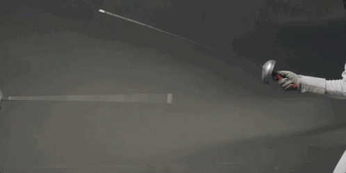 A Woman Is Holding A Sword In Her Hand While Wearing A Mask . GIF