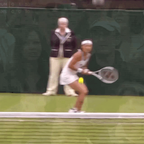 a woman is holding a tennis racquet and playing tennis
