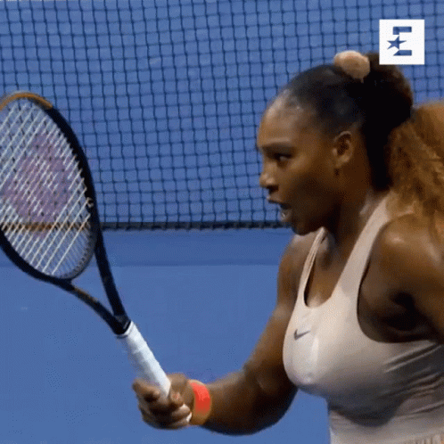 A Woman Is Holding A Tennis Racquet In Front Of A Net With The Letter E On It GIF