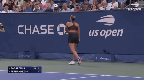 a woman is holding a tennis racquet in front of a scoreboard that says 98 mph serve speed