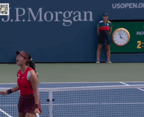 A Woman Is Holding A Tennis Racquet In Front Of A Sign For The Us Open GIF