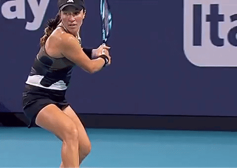 a woman is holding a tennis racquet on a court in front of an advertisement for lte