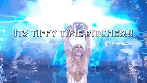 A Woman Is Holding A Trophy In The Air With The Words " Its Tiffy Time Bitches " Written Below Her GIF