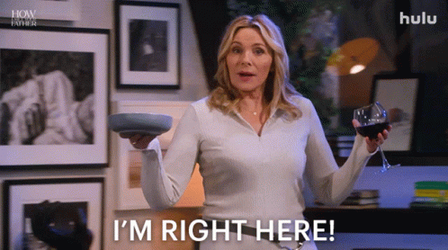 A Woman Is Holding A Wine Glass And A Plate And Says I 'M Right Here GIF