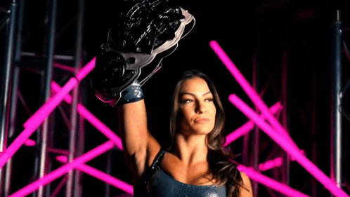 a woman is holding a wrestling glove over her head with the words evolve champion behind her