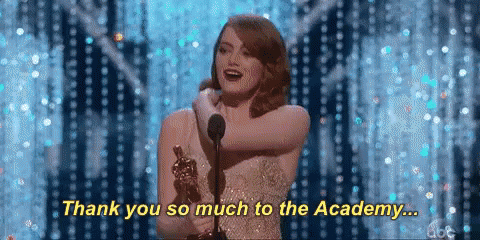 A Woman Is Holding An Oscar Trophy And Saying Thank You So Much To The Academy GIF
