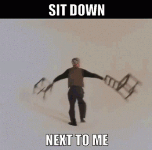 A Woman Is Holding Chairs In Her Hands With The Words Sit Down Next To Me GIF