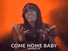 A Woman Is Holding Her Hands Up In The Air And Singing A Song . GIF