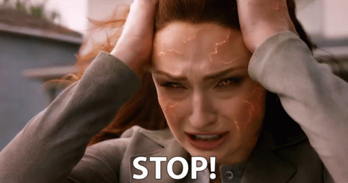 A Woman Is Holding Her Head With The Word Stop Written On It GIF