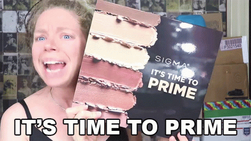 A Woman Is Holding Up A Sigma It 'S Time To Prime Book GIF
