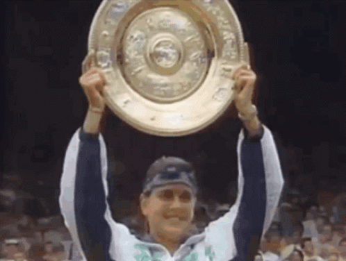a woman is holding up a trophy that says ' winner ' on it