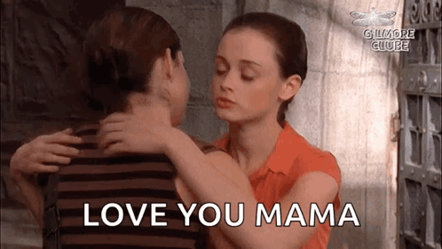 A Woman Is Hugging A Man With The Words `` Love You Mama '' Written On The Bottom . GIF