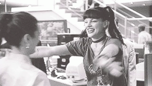A Woman Is Hugging Another Woman In A Black And White Photo . GIF