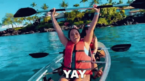 A Woman Is In A Clear Kayak With Her Arms In The Air And The Word Yay Is Above Her GIF