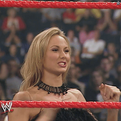 A Woman Is In A Wrestling Ring With A W Logo On Her Arm GIF