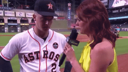 A Woman Is Interviewing A Baseball Player Who Is Wearing A Jersey That Says Astros GIF