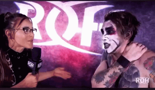 Woman Interviewing Wrestler With Microphone GIF