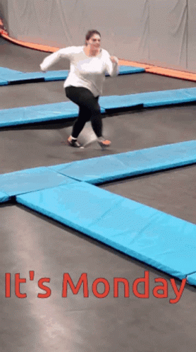 a woman is jumping on a trampoline with the words " it 's monday " on the bottom