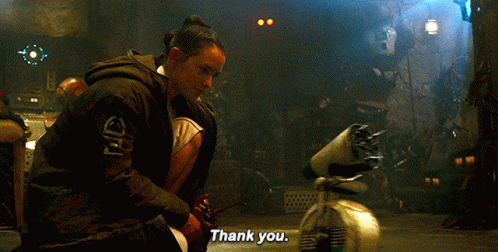 A Woman Is Kneeling Down In Front Of A Robot And Saying Thank You GIF
