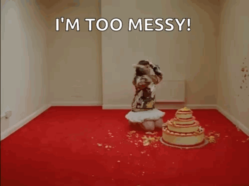A Woman Is Kneeling In Front Of A Cake In A Room . GIF