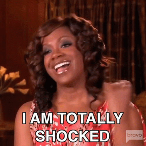 A Woman Is Laughing And Saying " I Am Totally Shocked " . GIF